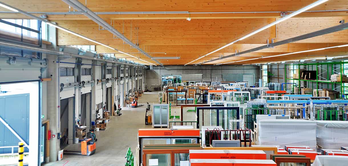 Versandhalle Süd-Fensterwerk von innen mit Holzdachkonstruktion und gelagerten Fensterelementen
